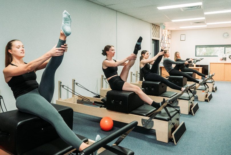 Clients working their legs on the reformer